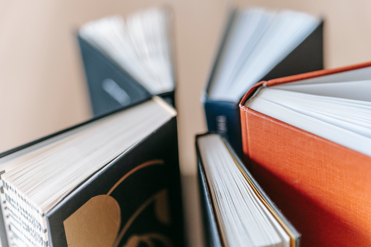 Set of various books arranged on table